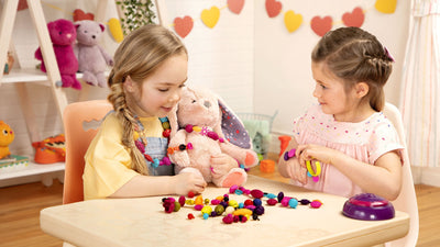 Two little girls sitting and playing with toys