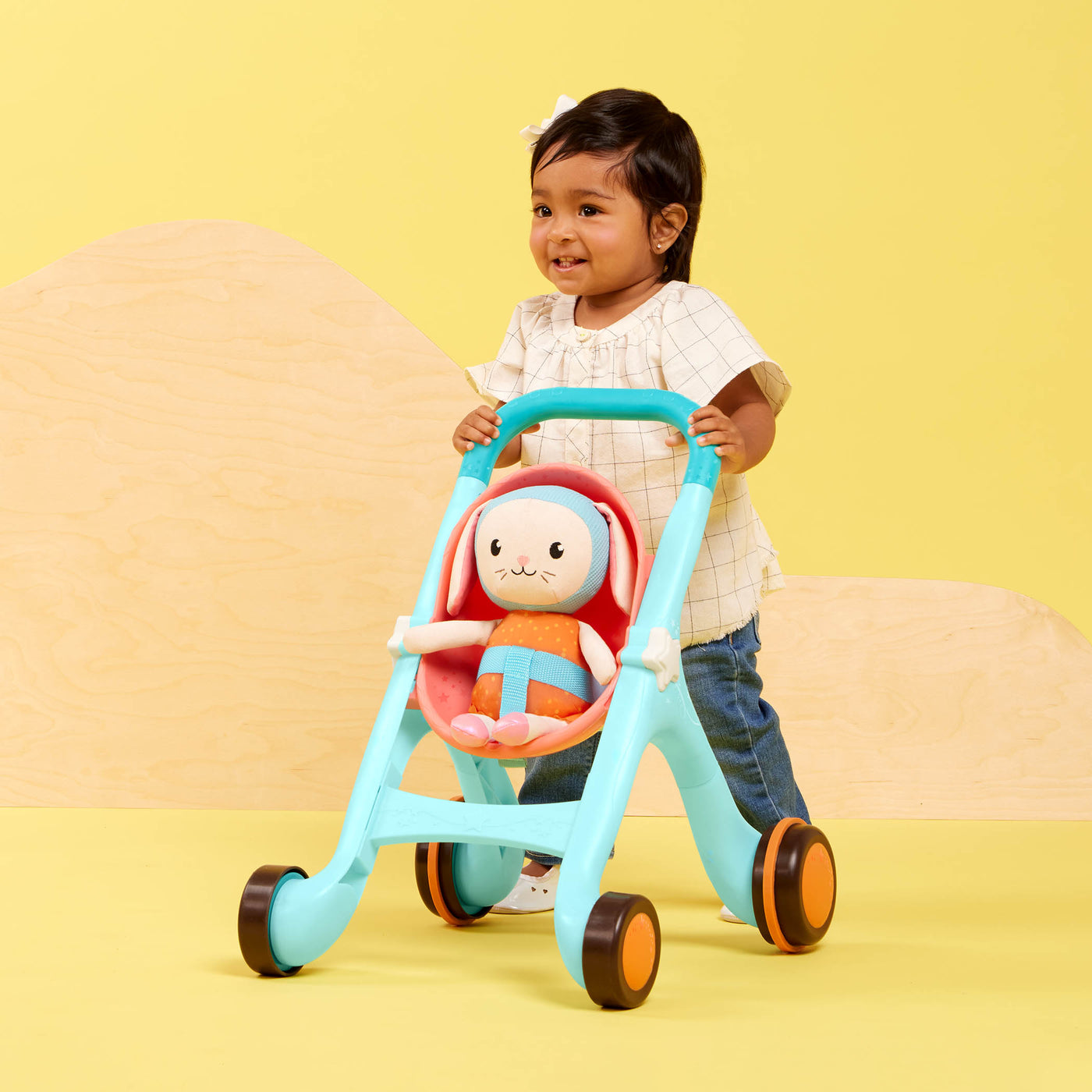 Toy stroller with plush bunny.